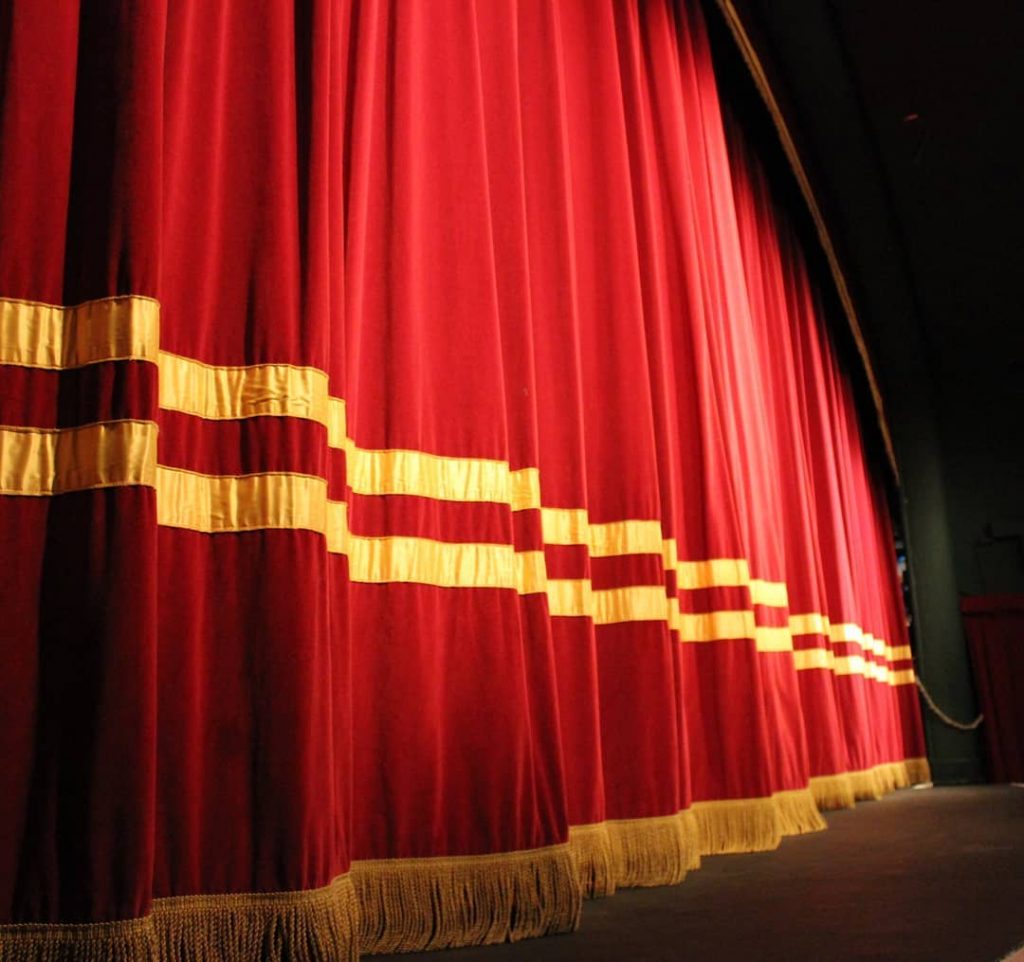 The main stage at the Little Theatre with the curtains closed